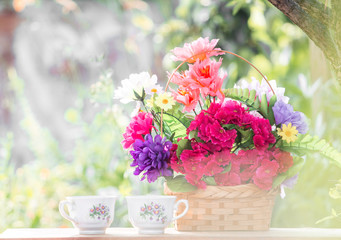Obraz na płótnie Canvas Good morning with good breakfast. Basket with flowers outdoors, blurred background