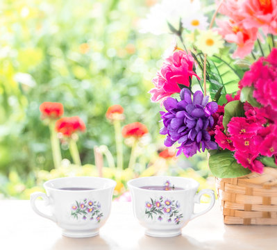 Good morning with good breakfast. Basket with flowers outdoors, blurred background