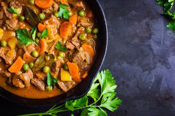 beef stew with vegetables on dark background
