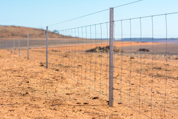 Barbed wire fence on dry land at west Australia