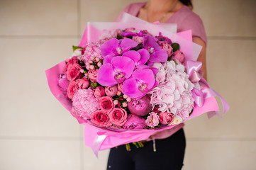 woman holding bright pink bouquet