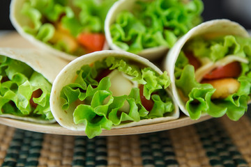 rolls fastfood.  chicken nuggets, lettuce, tomato, cheese, Mexican tortillas