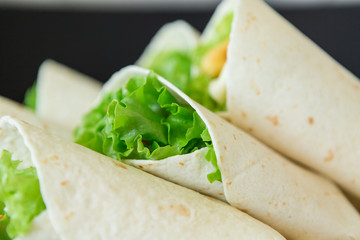 rolls fastfood.  chicken nuggets, lettuce, tomato, cheese, Mexican tortillas