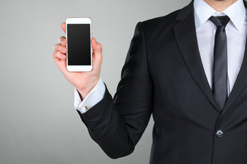 Close up of a businessman using mobile smart phone