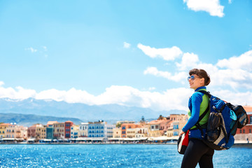 Fototapeta na wymiar woman tourist walking on the waterfront of Chania bay backround, Crete, Greece
