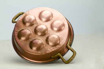 old copper pot for eggs isolated.