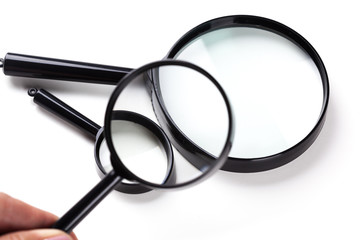 Three magnifiers over white