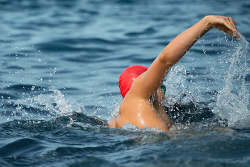 Man swimmer swimming crawl in blue sea