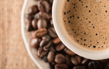 Fresh coffee and coffee beans on a table