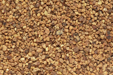 Organic Nutmeg (Myristica fragrans) in big cut size. Macro close up background texture. Top view.