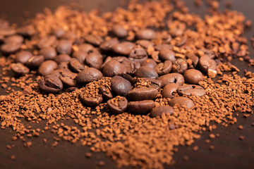 Coffee beans and ground coffee oт brown table