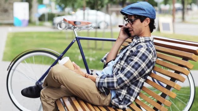 man calling by smartphone sitting on street bench 48