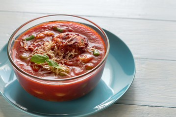 Portion of minestrone soup with meatball