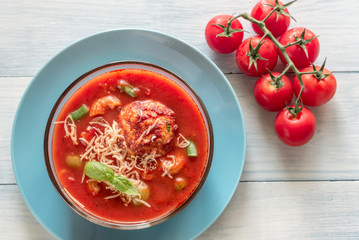 Portion of minestrone soup with meatball