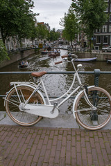 On white bike on the pavement near canals in Amsterdam