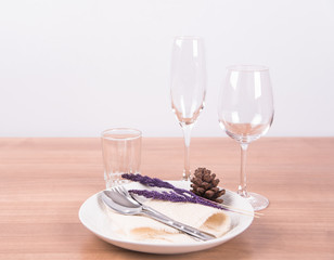 Dining table setting white plate with flower, wineglass, vintage