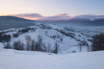 Fototapeta na wymiar Winter mountain hills at sunrise