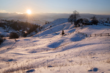 Fototapeta na wymiar Winter sunset at mountain hills
