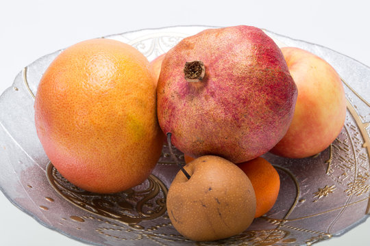 mix fresh fruits on plate isolated on white