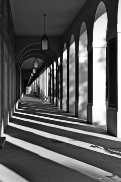 Long Arcade In Munich, Germany. Classical Gallery With Contrasting Geometric Shadows In Perspective. Black And White.