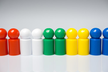 Row of colorful pawns for board games