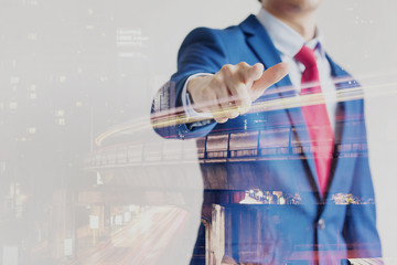 Double exposure of confident businessman dissolved with night cityscape