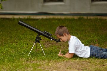 happy little boy with telescope