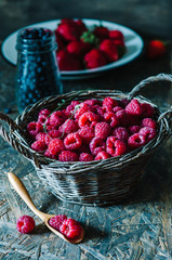 Fresh organic raspberry in basket. Selective focus