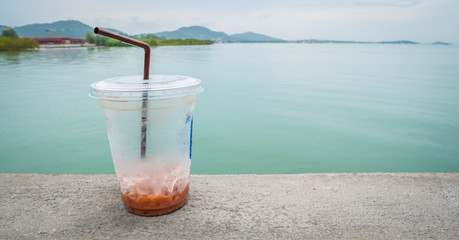  ice chocolate in plastic glass with sea view