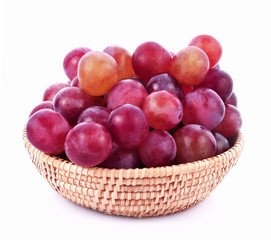Fototapeta premium Red grapes in basket on white background