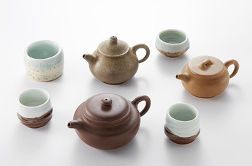 Chinese teapot and cups on white background