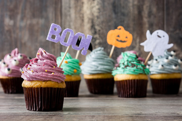 Halloween cupcakes on a rustic wooden table

