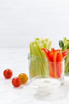 healthy snacks, mixed vegetables and yogurt on a white table