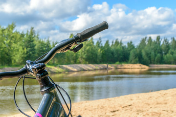 Fototapeta na wymiar Bike stands on the banks of the river