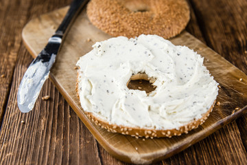 Cream cheese Bagel (on wooden background)