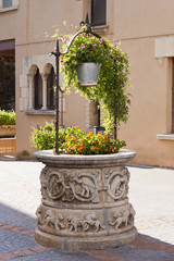 Antique sculpted water well in Roc de Sant Gaieta