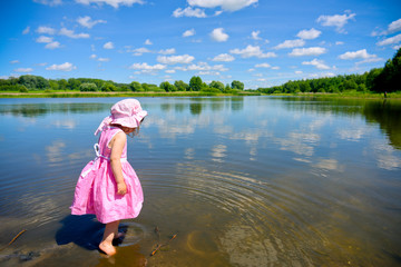 Cute little girl playing in the water