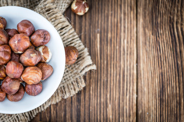 Hazelnuts on vintage wooden background (selective focus)