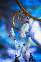 Dreamcatcher against a white blur of snow