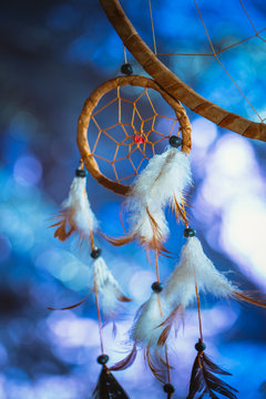 Dreamcatcher against a white blur of snow