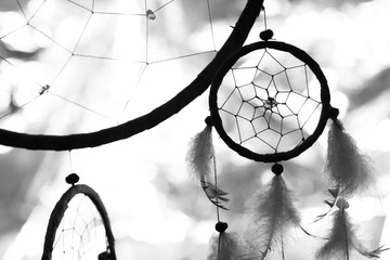 black and white photo of a dream catcher at sunset purple dark background