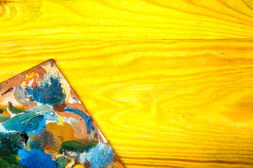Fototapeta premium Painting palette on colored wooden background