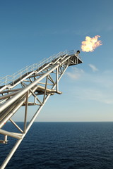 The gas flare is on the oil rig platform.