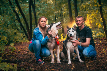 Naklejka na ściany i meble family with husky dogs in the forest