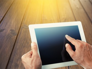 Hand holds the digital tablet.