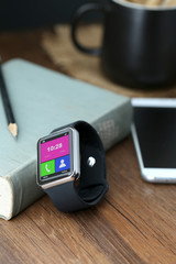 Smart watch and smartphone on the desktop