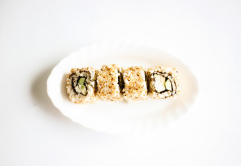 Sushi maki with lemon slices on the white plate