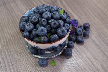 Freshly picked blueberries   in a porcelain dish. Juicy and fresh blueberries - Blueberry antioxidant. - Concept for healthy eating and nutrition
