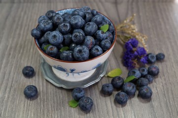 Freshly picked blueberries   in a porcelain dish. Juicy and fresh blueberries - Blueberry antioxidant. - Concept for healthy eating and nutrition
