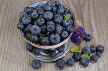 Freshly picked blueberries   in a porcelain dish . Juicy and fresh blueberries - Blueberry antioxidant. - Concept for healthy eating and nutrition
